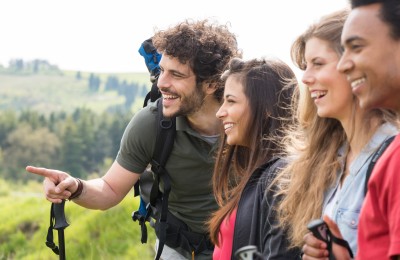 Group Of Happy Hikers Enjoying Trip In Countryside
